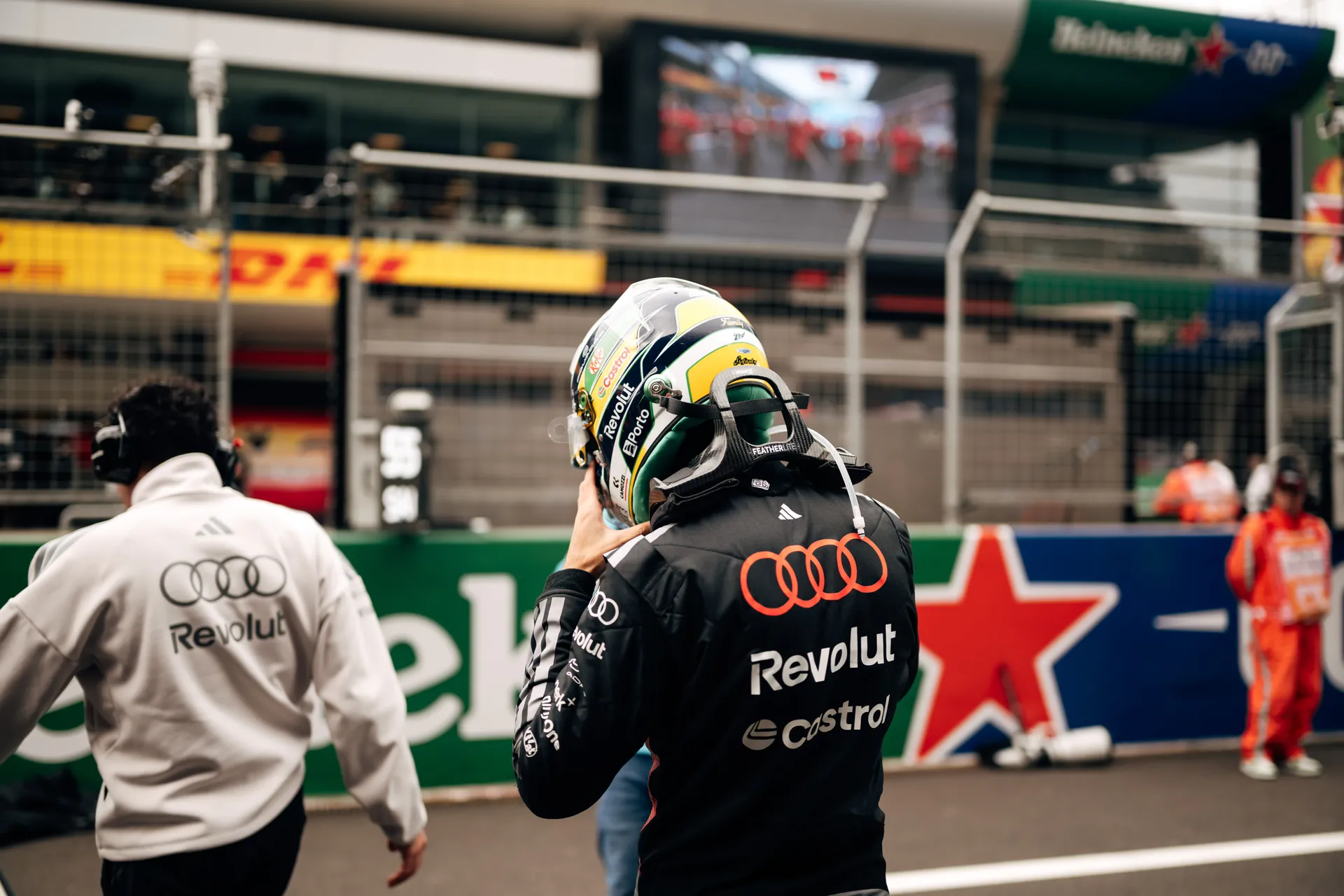 Rear view of Gabriel Bortoleto walking on the grid in Audi Revolut F1® Team race kit and helmet before the Chinese Grand Prix.