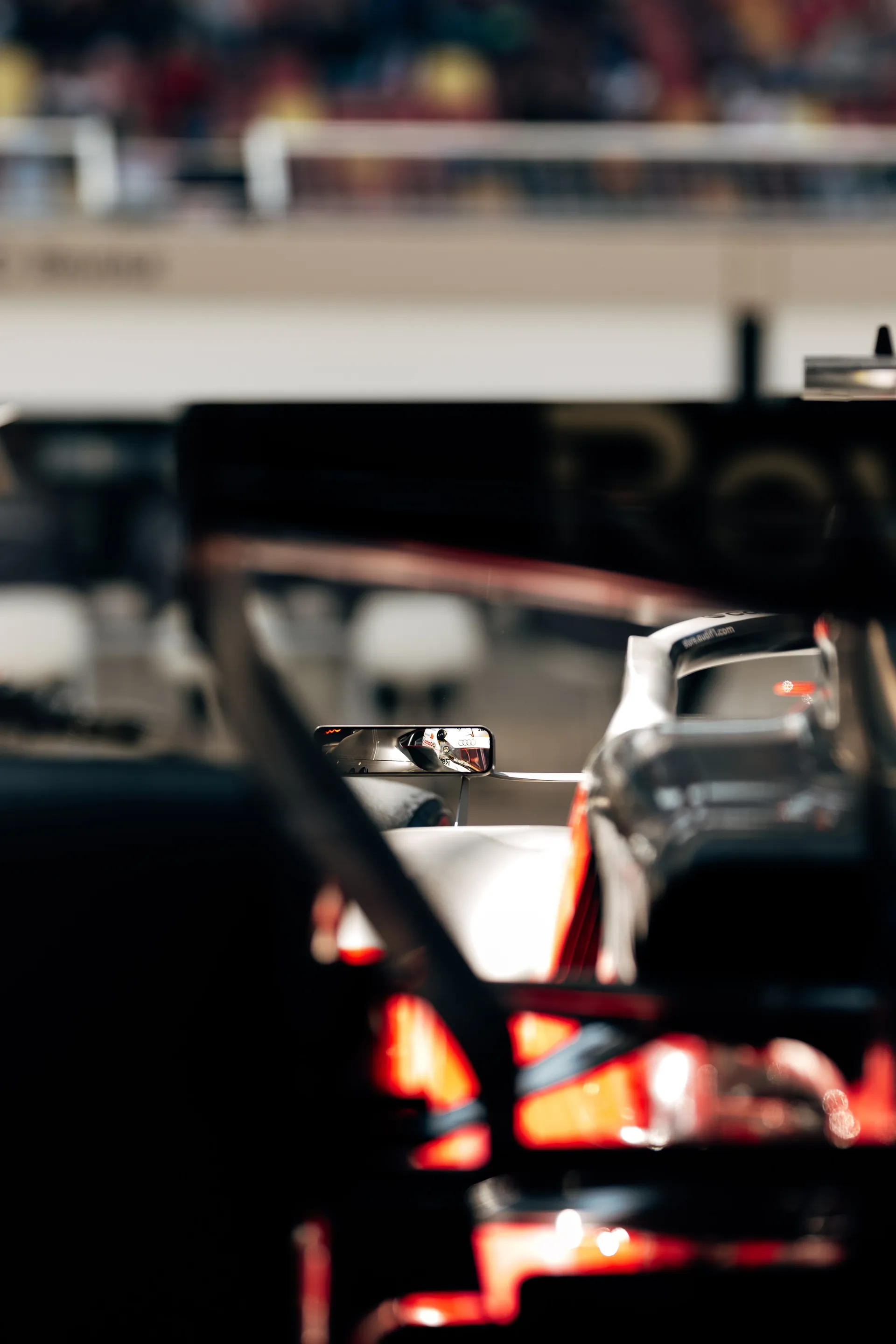 A close view through the garage frames the rear section of the Audi Revolut F1® Team car during preparations in Shanghai.
