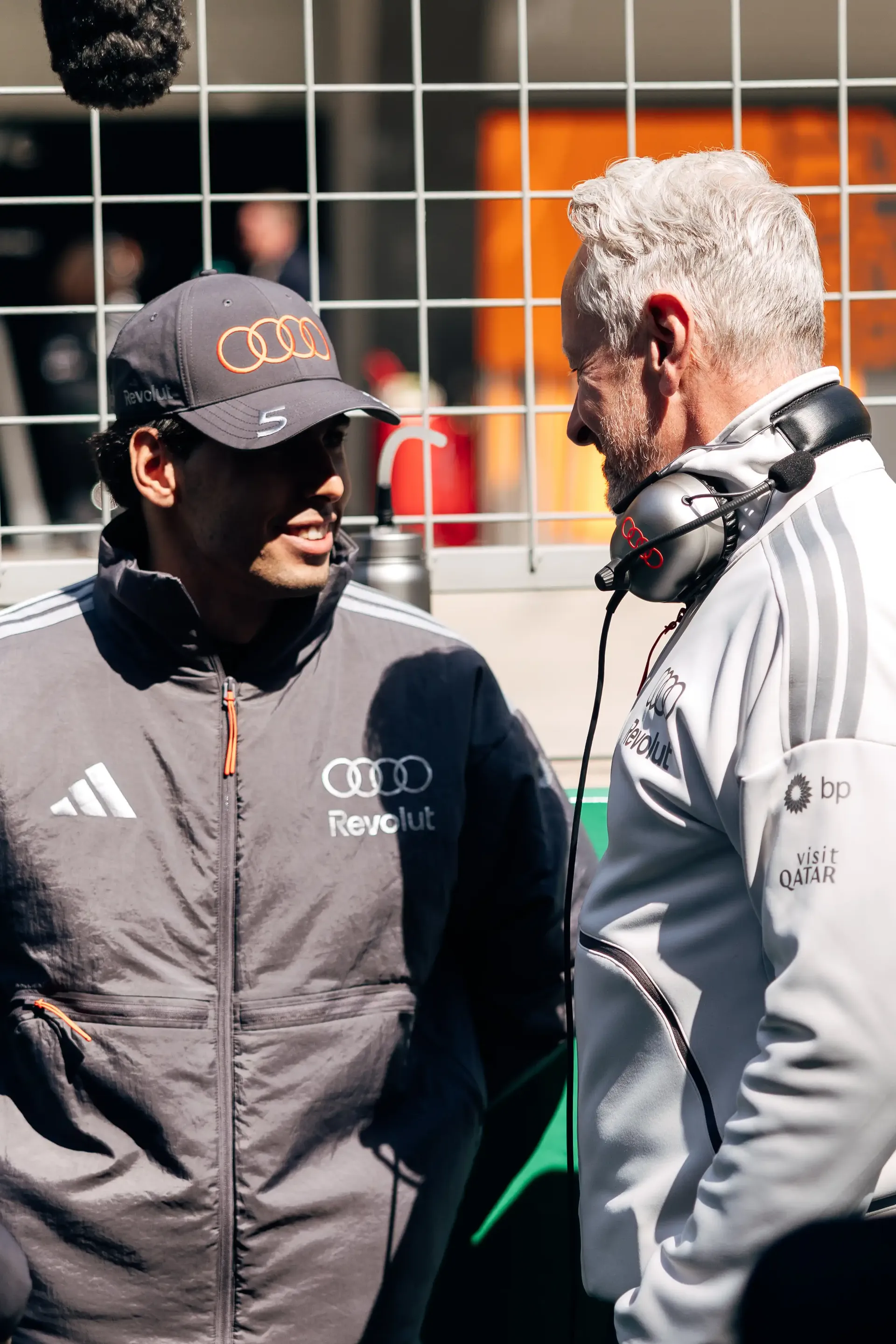 Audi Revolut F1® Team driver Gabriel Bortoleto speaking with Team principal Jonathan Wheatley in the pit lane before track action.