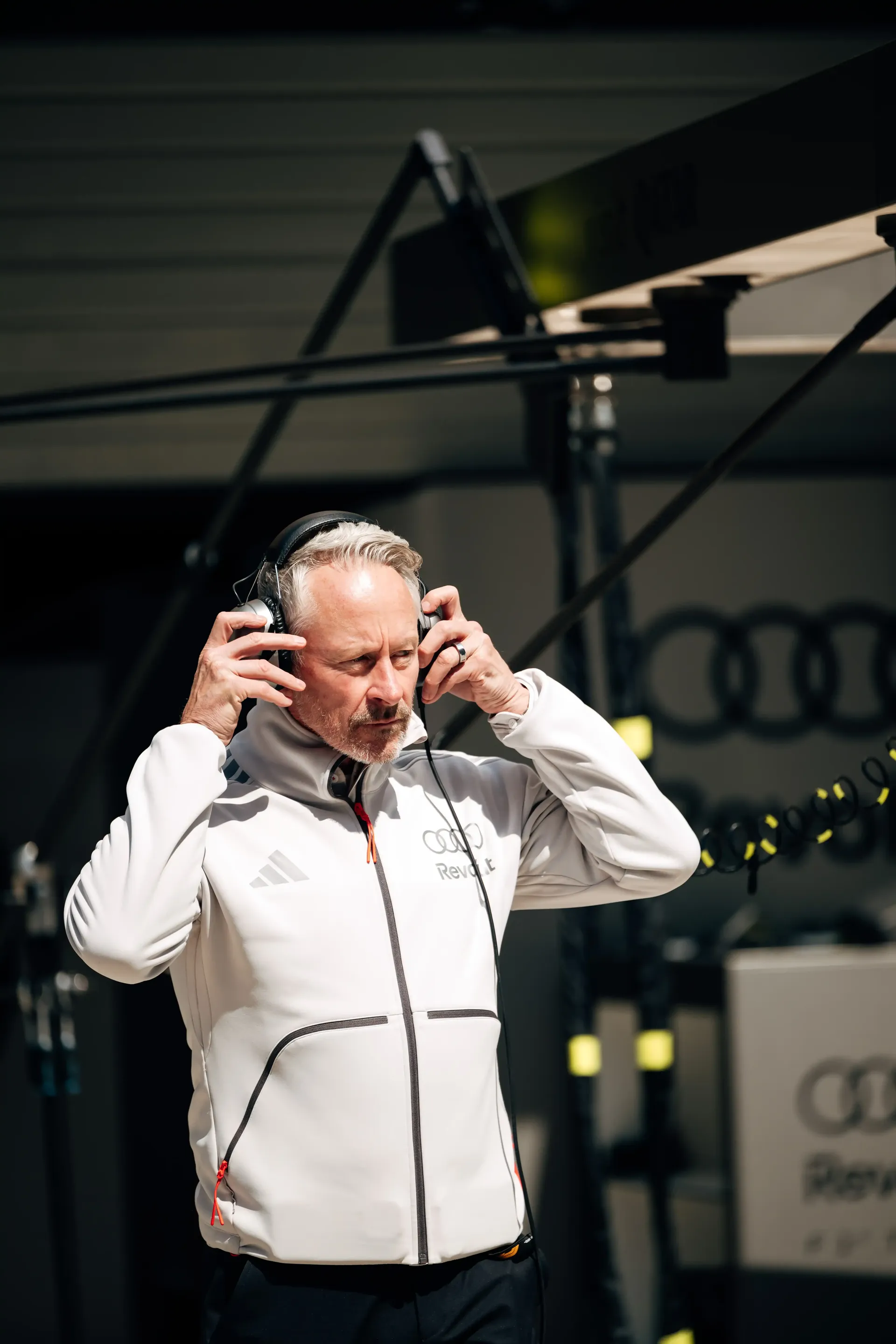 Audi Revolut F1® Team principal Jonathan Wheatley adjusting his headset in the Formula 1 garage during the Chinese Grand Prix sprint weekend.