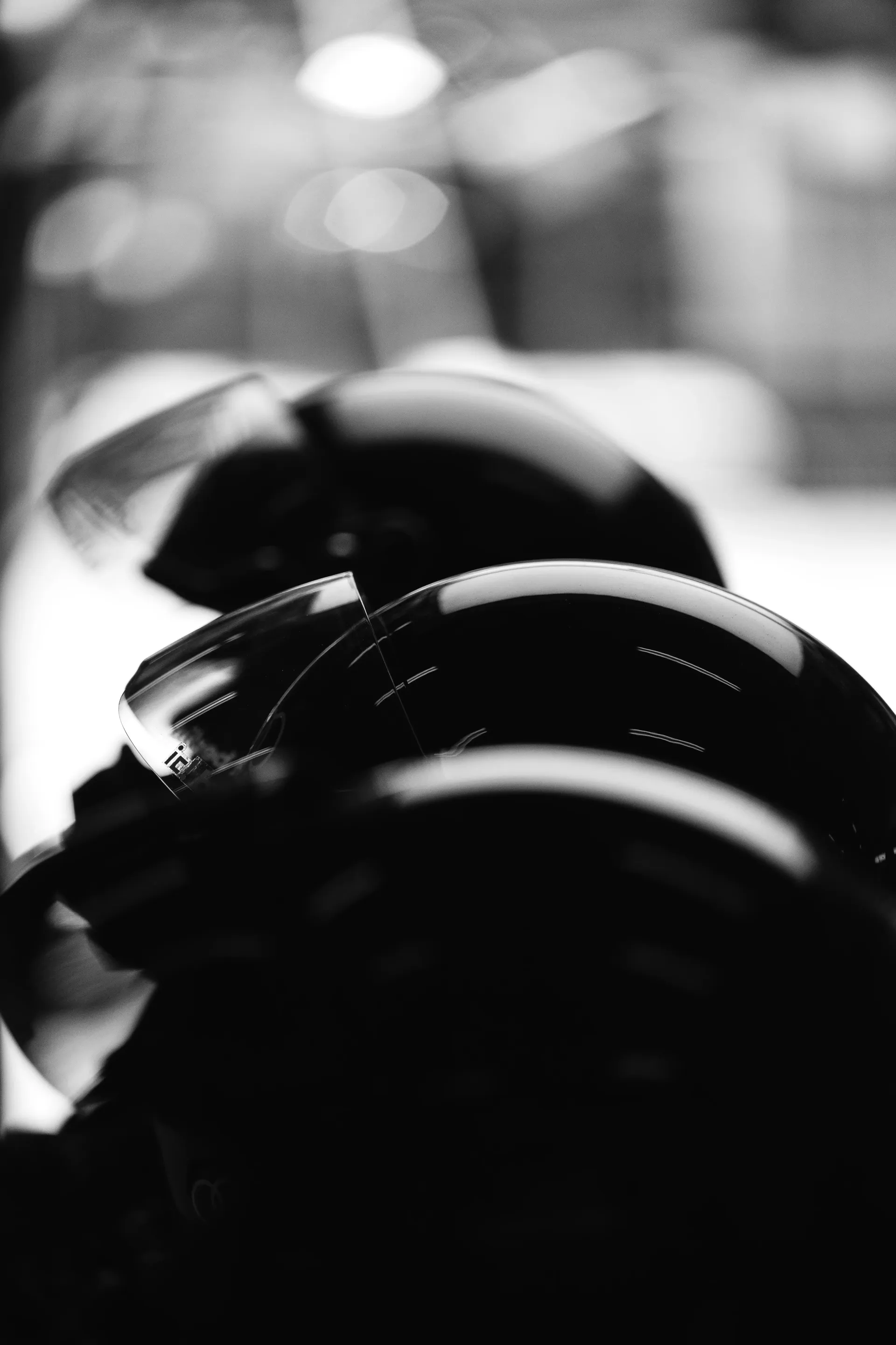 Close-up silhouette of Audi Revolut F1® Team pit equipment and helmets inside the garage.