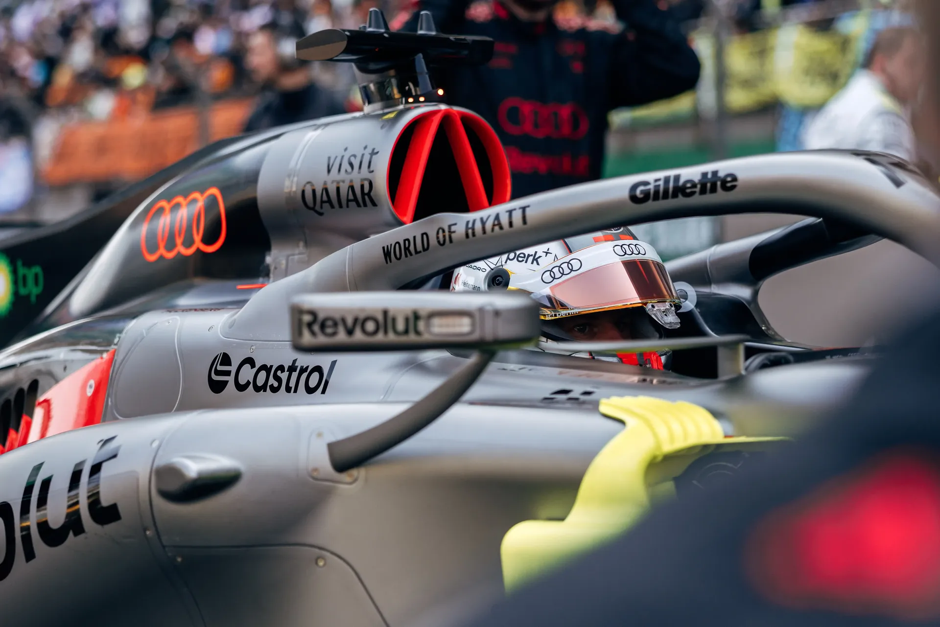 Close-up of Nico Hukenberg in cockpit of the Audi Revolut F1® Team R26 car in the pit lane during the Chinese Grand Prix sprint weekend, showing aerodynamic details and sponsor logos.