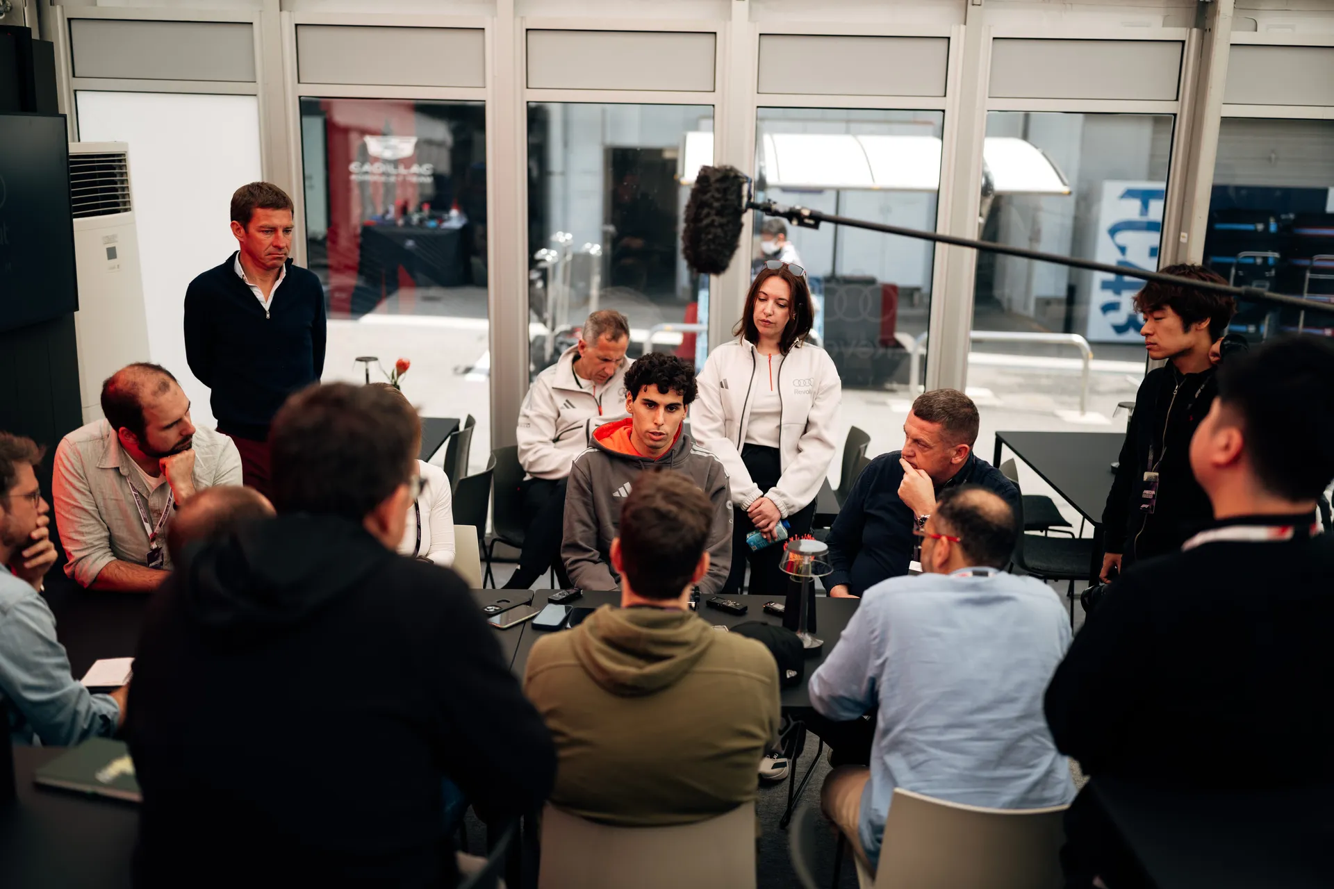 Gabriel Bortoleto speaks to a group during a team meeting inside the Audi Revolut F1® Team hospitality area.