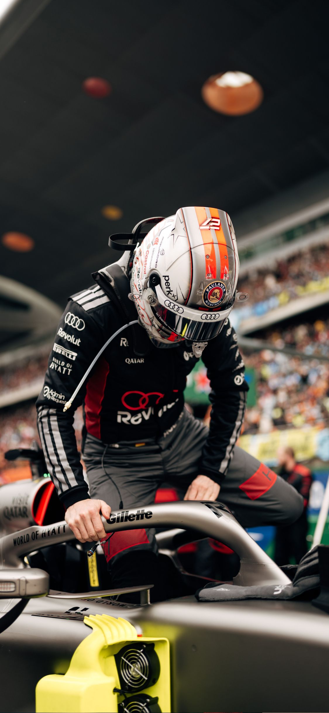 Nico Hulkenberg climbs into the Audi Revolut F1® Team car on the grid before the race in Shanghai.