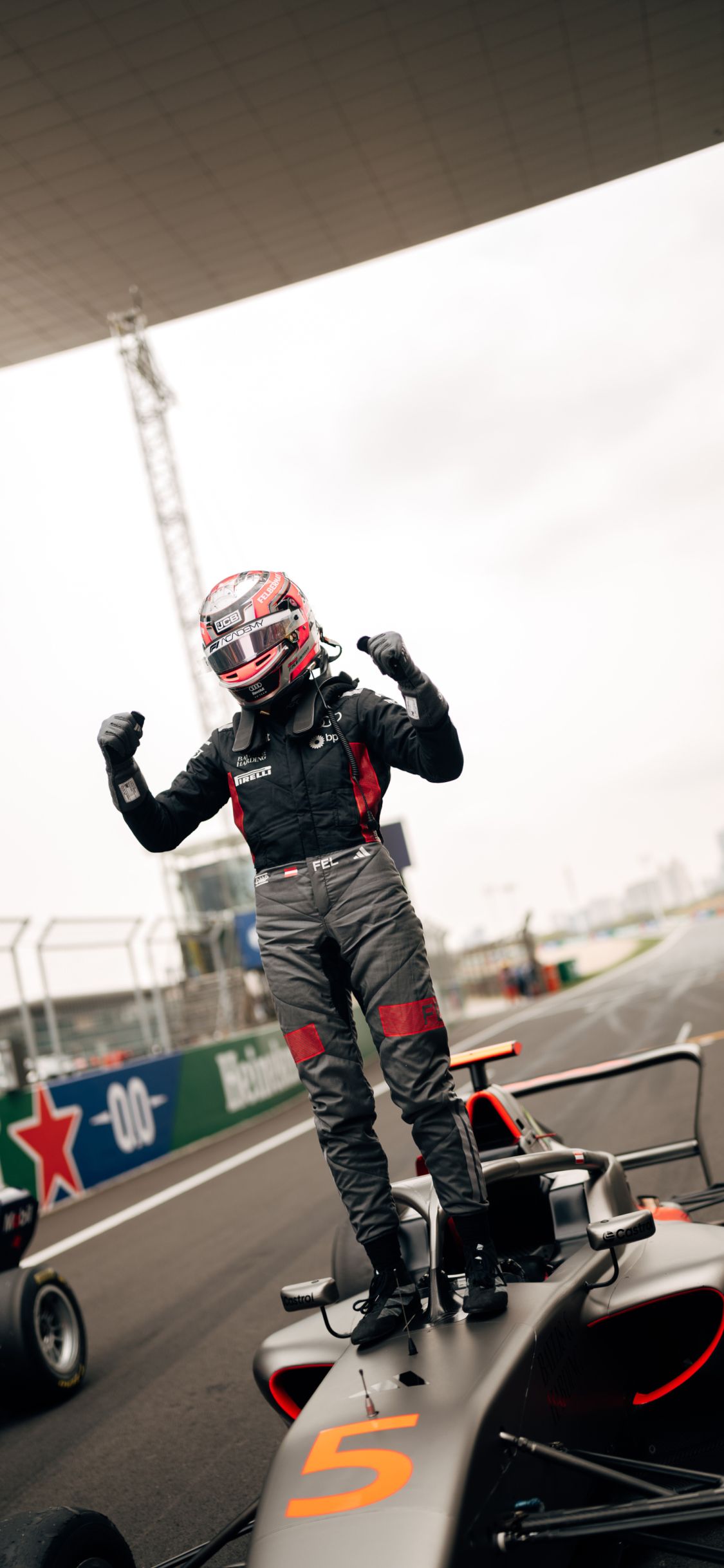 Emma Felbermayr stands on top of her F1 Academy car celebrating after the race in Shanghai.