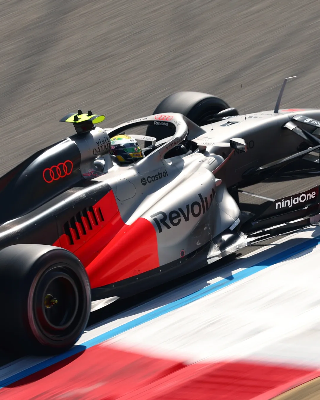 Close up action shot of the Audi Revolut F1® Team car on track, motion blur emphasizing speed and aero details.