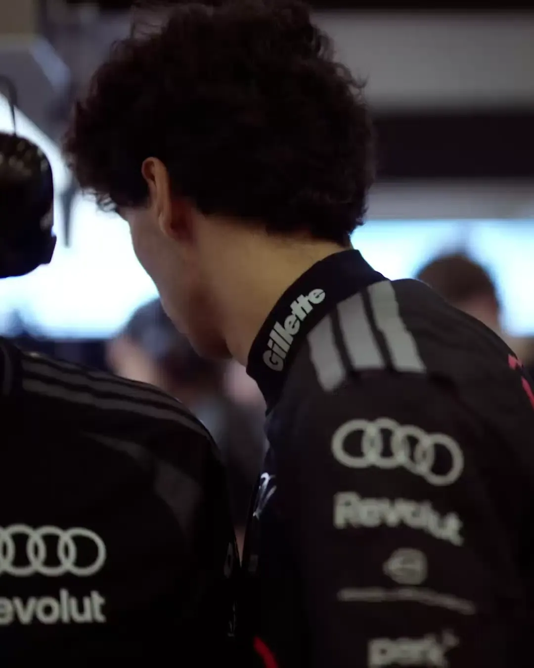 Audi Revolut F1® car inside the garage, driver inside the garage close up, Gabriel Bortoleto walking inside
