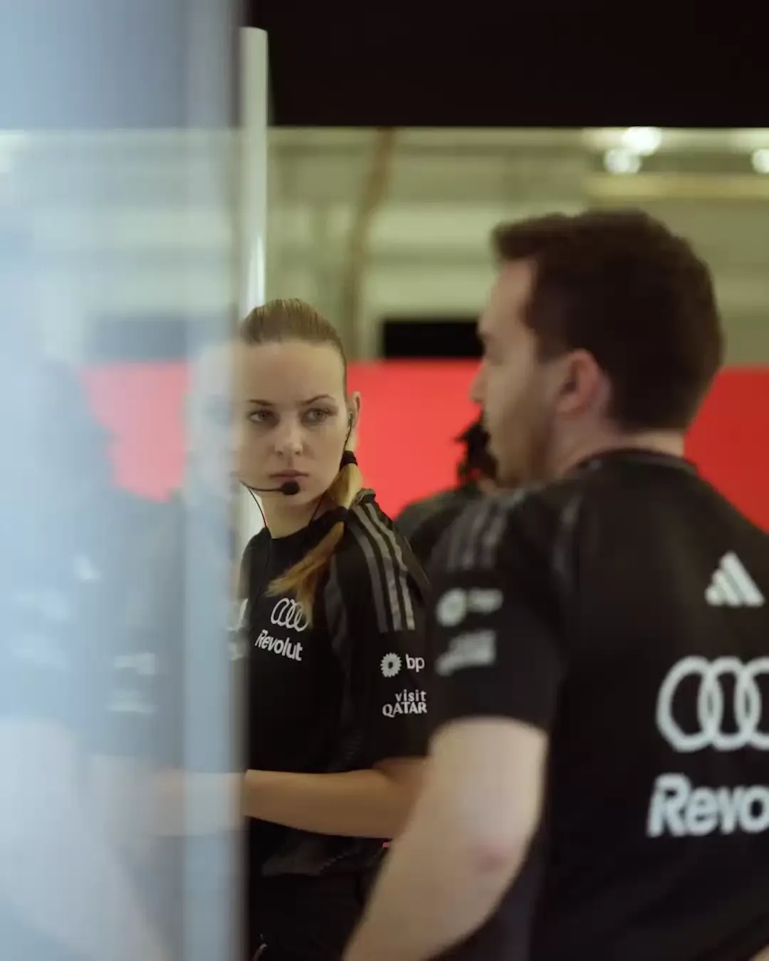 Audi Revolut F1®  inside the garage, crew members, close up, black t shirts with Audi and Revolut Logo