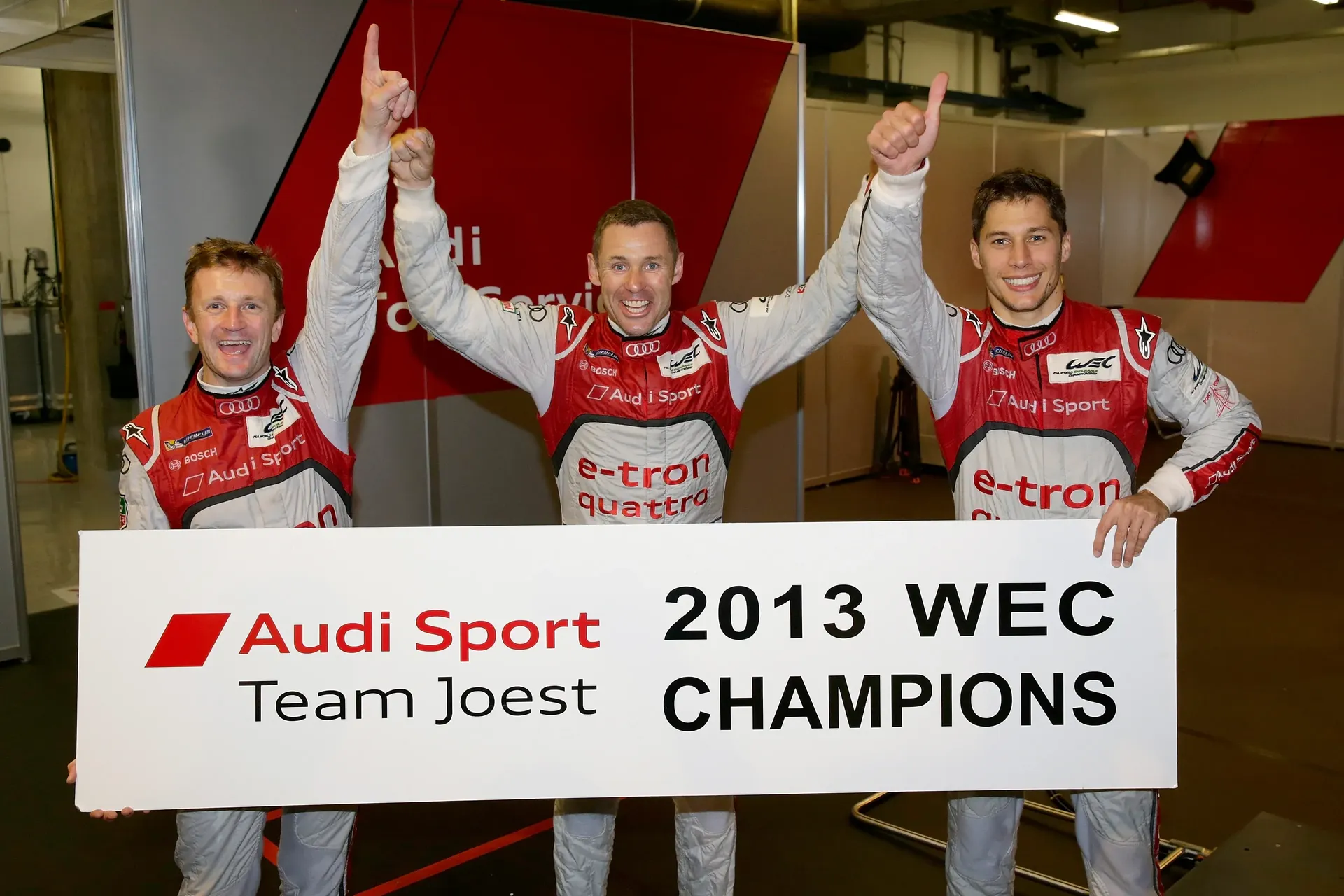Tom Kristensen, Allan McNish and teammate celebrate Audi Sport's 2013 FIA World Endurance Championship title.