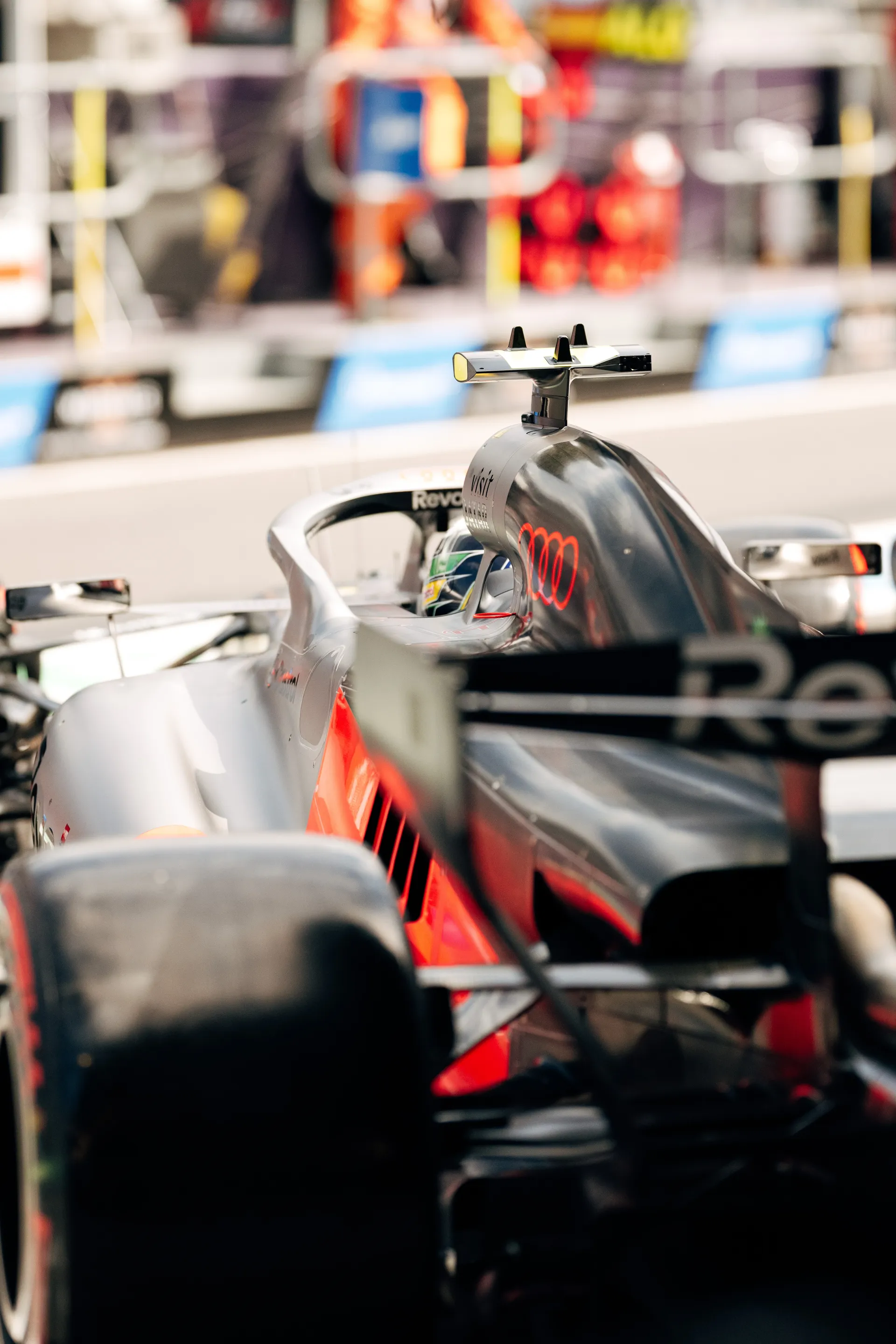 Close up of an Audi Revolut F1® Team car in the pit lane with the cockpit and halo in focus during qualifying.
