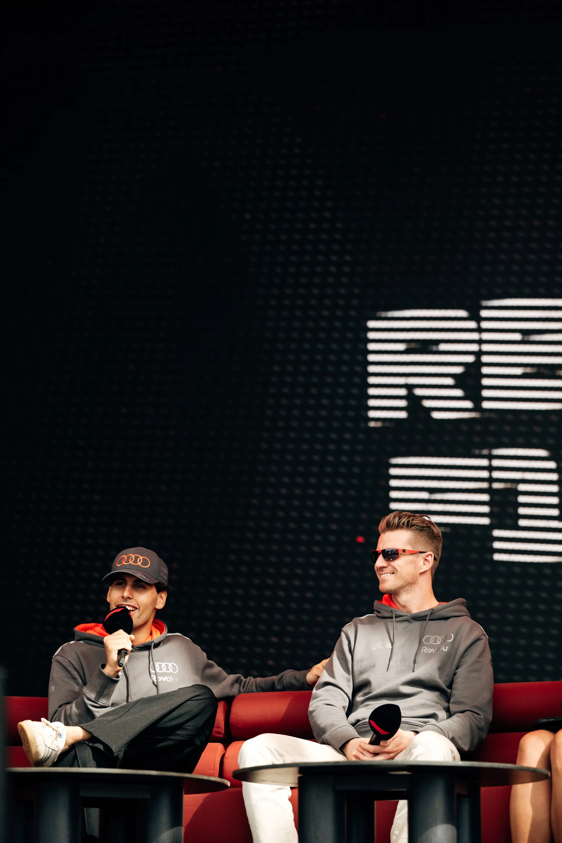 Audi Revolut F1® Team drivers Niko Hulkenberg and Gabriel Bortoleto sit on stage during a live fan interview session in Melbourne.