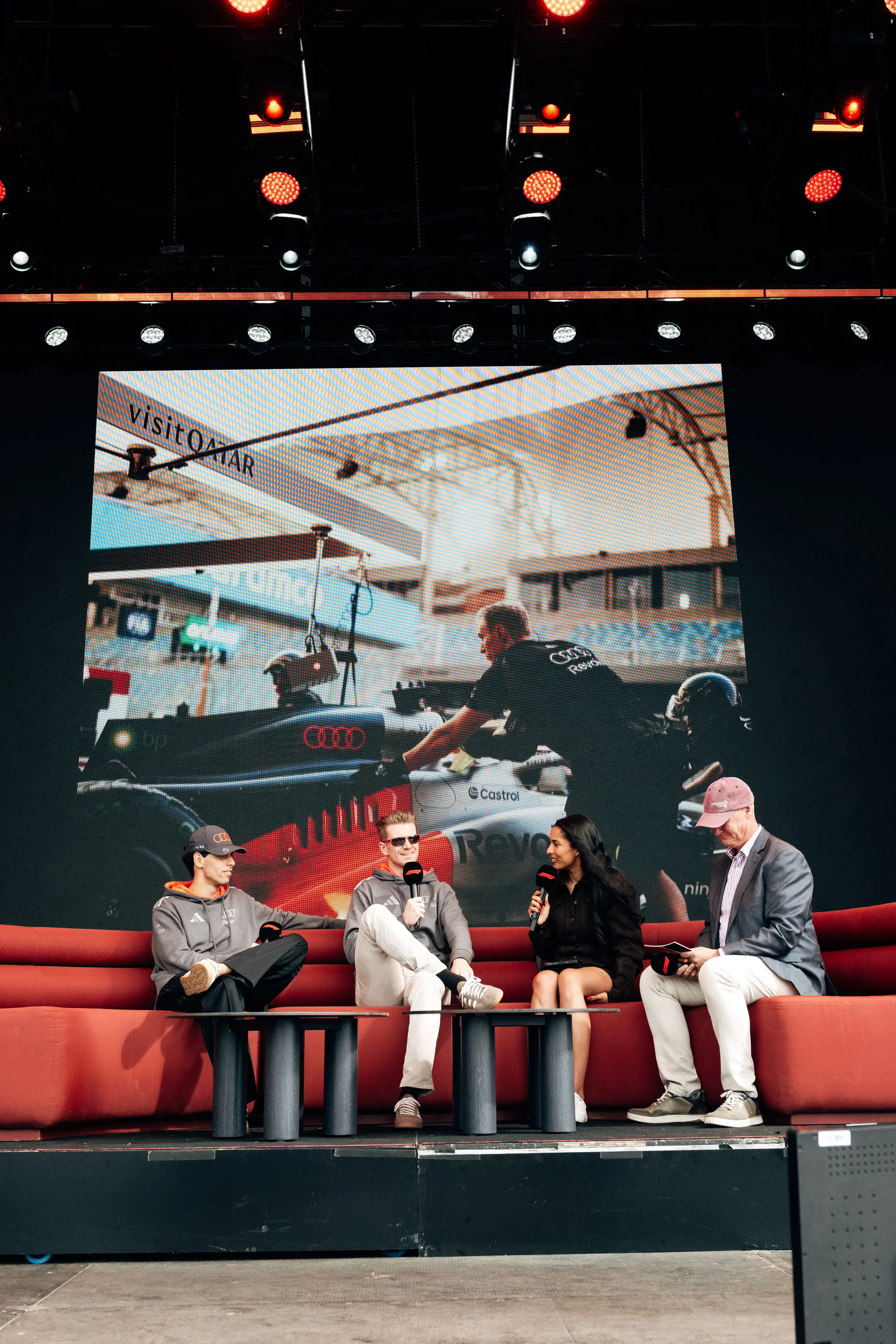 Audi Revolut F1® Team drivers Niko Hulkenberg and Gabriel Bortoleto join a host on stage for a live Audi Revolut F1® Team fan talk in Melbourne.