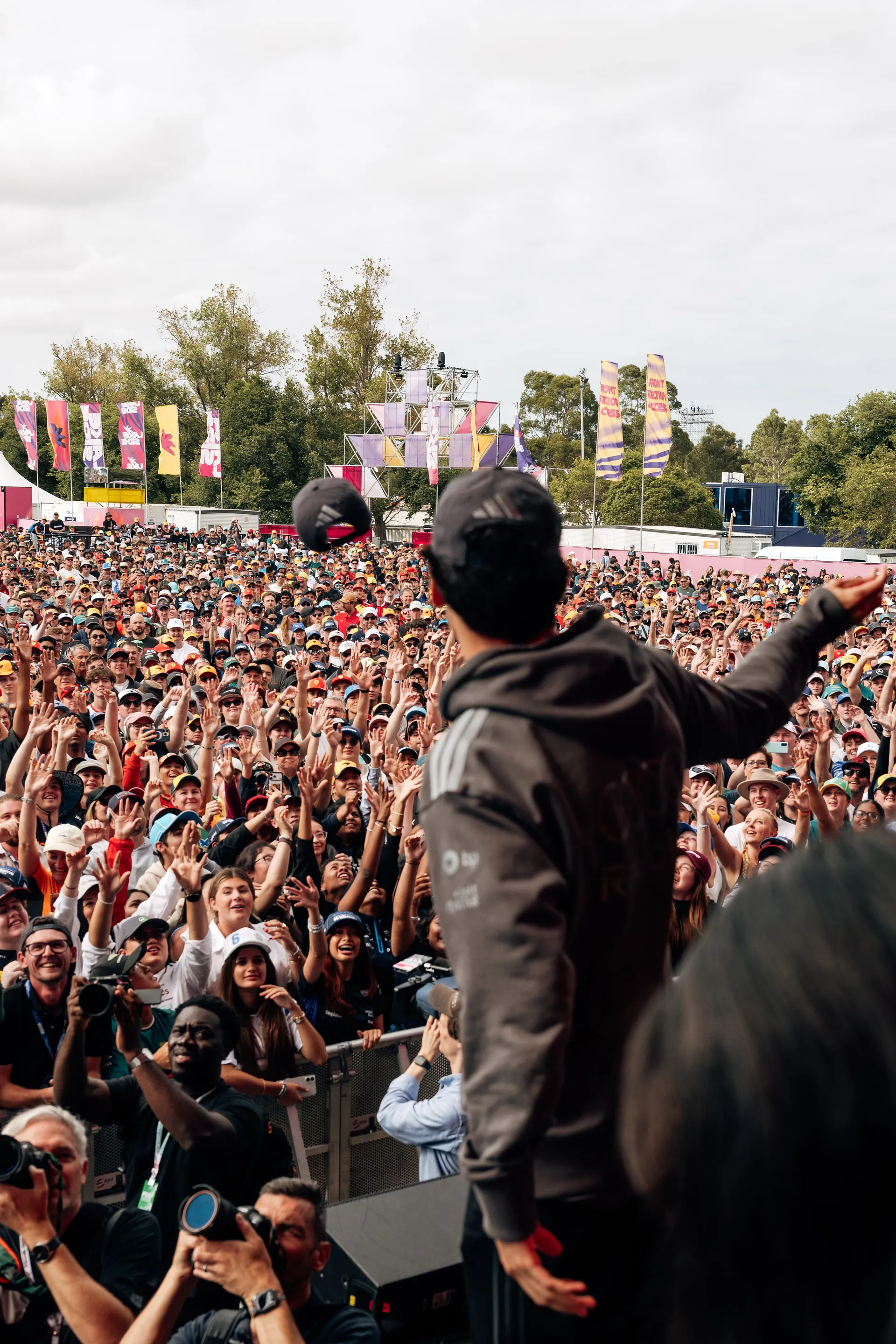 An Audi Revolut F1® Team driver Gabriel Bortoleto gestures to a large Melbourne crowd during an Audi Revolut F1® Team stage event.