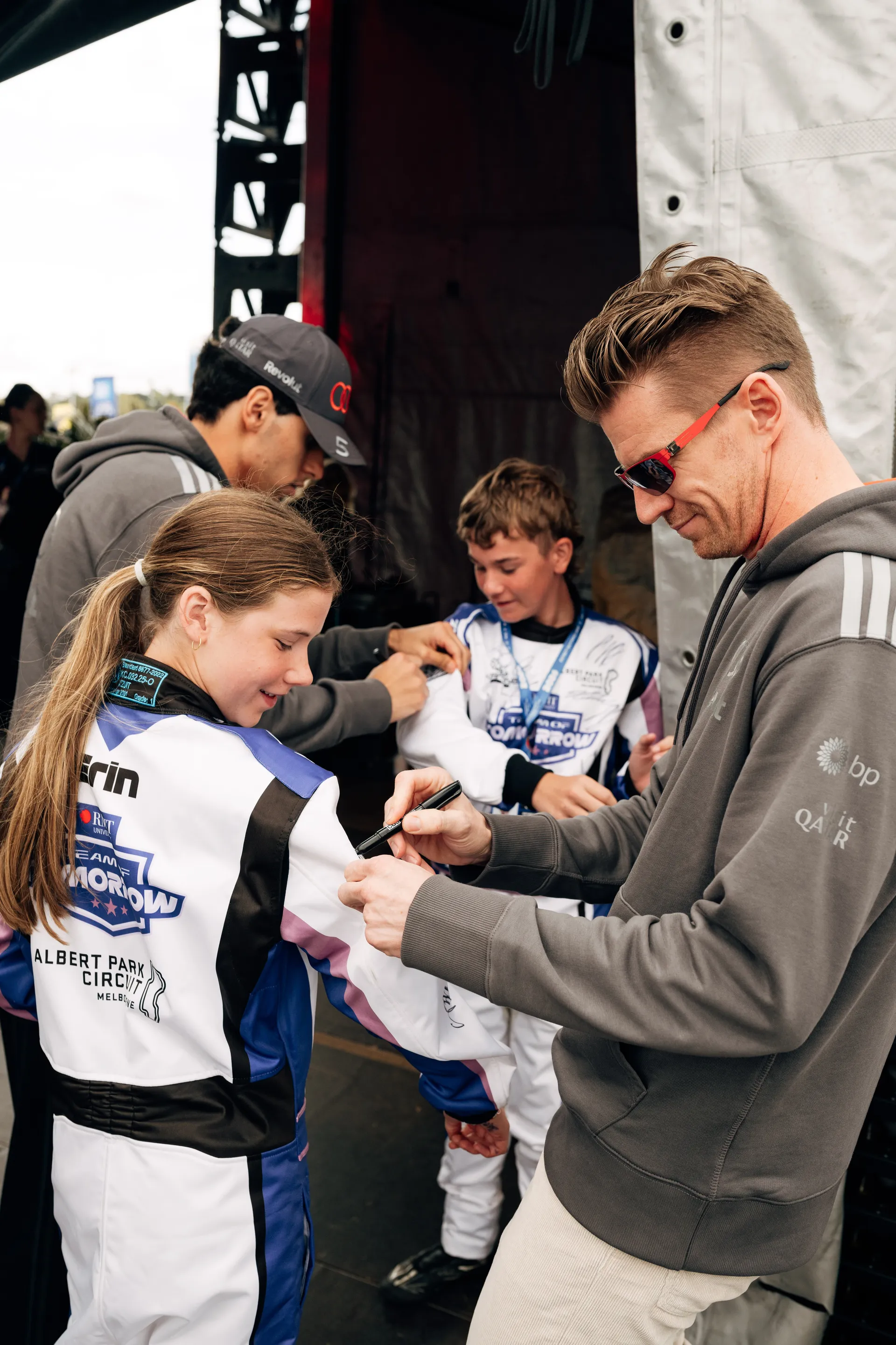Audi Revolut F1® Team drivers Niko Hulkenberg  sign merchandise for young fans backstage after a public appearance in Melbourne.