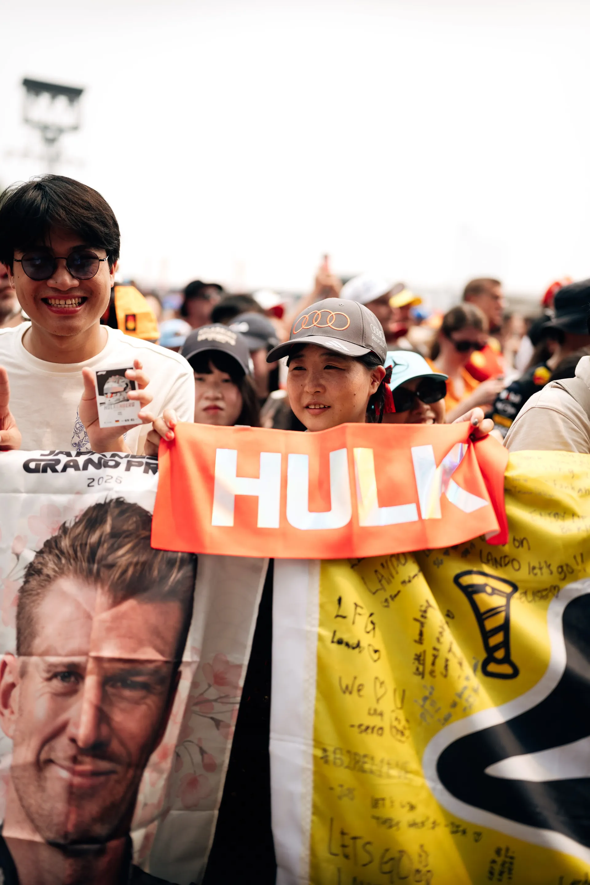Fans hold Audi Revolut F1® Team banners and driver merchandise during the Singapore Grand Prix.